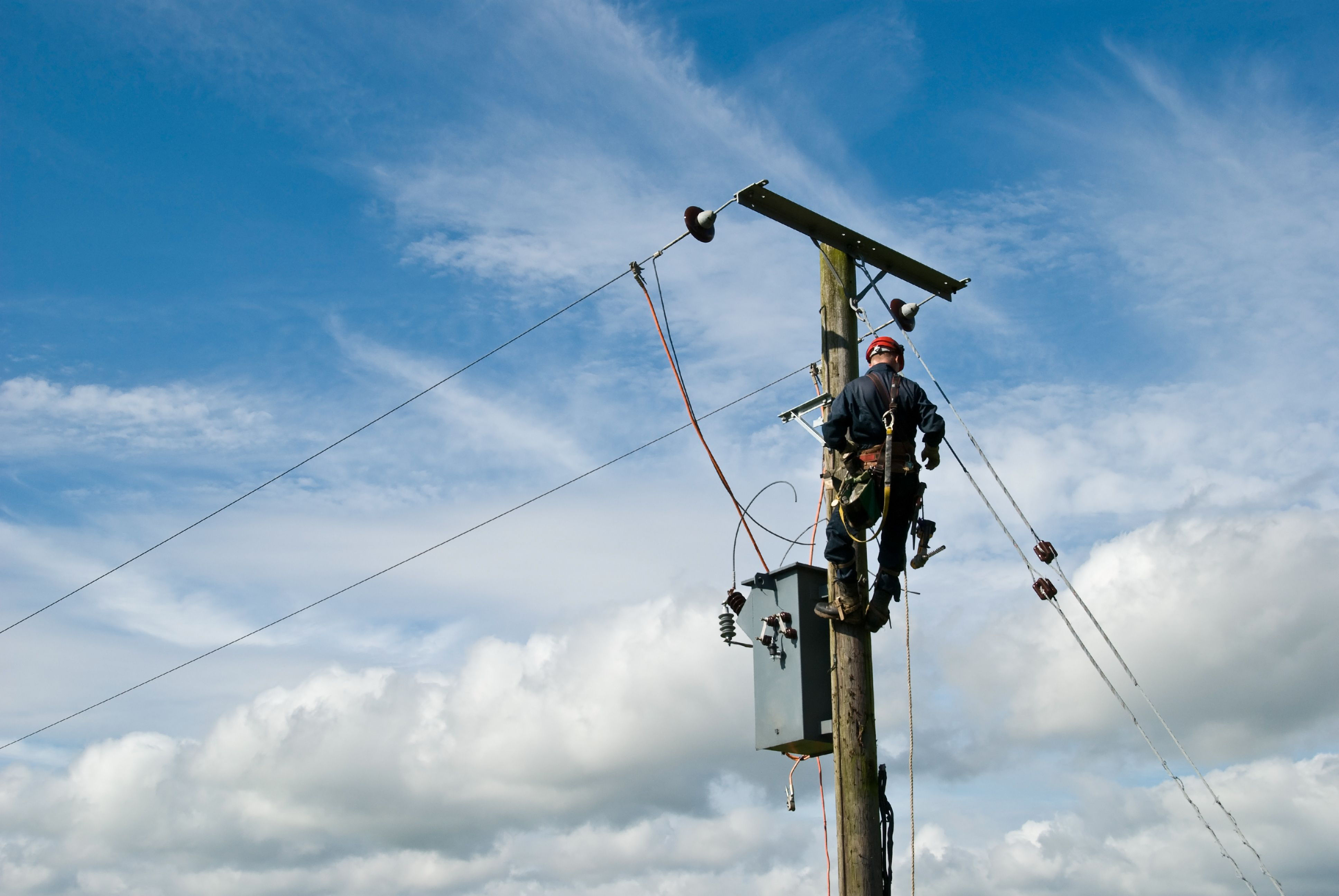 Worker on top of telephone pole